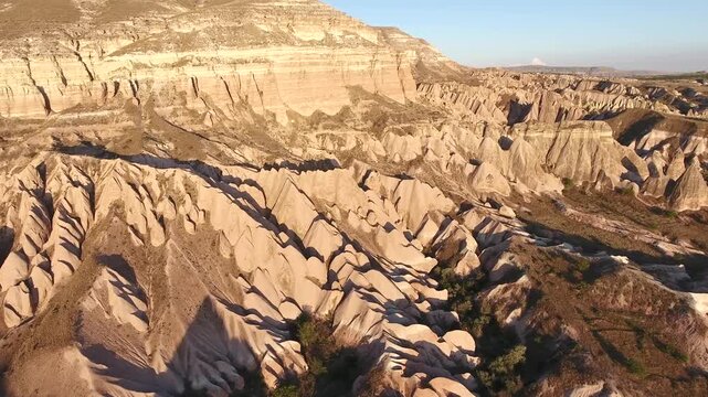Aerial views sweep across Cappadocia fairy chimneys, valleys, and eroded tuff landscapes.