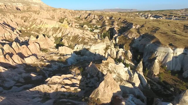 Aerial views sweep across Cappadocia fairy chimneys, valleys, and eroded tuff landscapes.