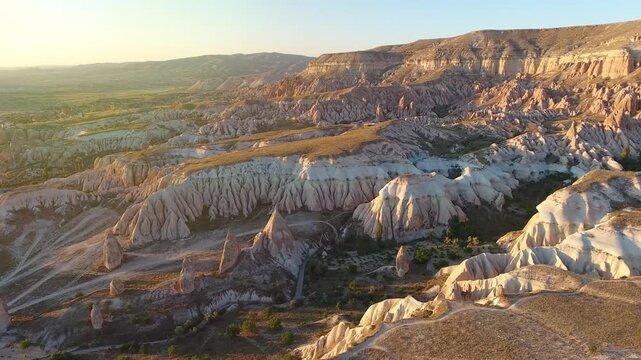 Aerial views sweep across Cappadocia fairy chimneys, valleys, and eroded tuff landscapes.