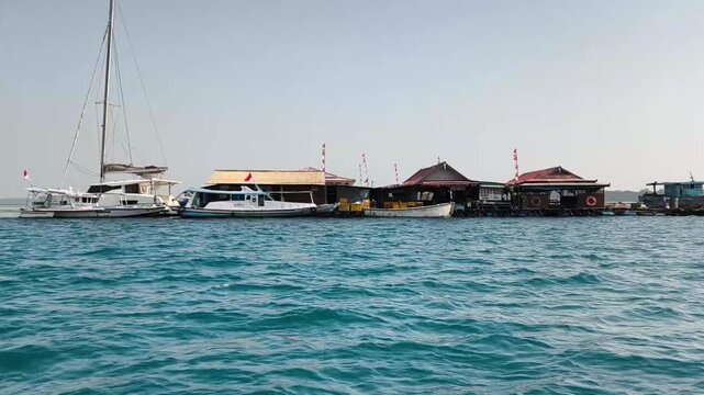 View of overwater gazebos and wooden structures on sea shore