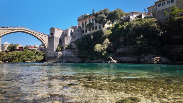 Scenic view of Neretva riverbank with terraces and hills in Mostar
