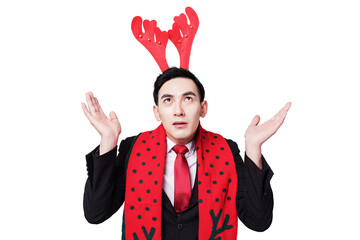Confused businessman in festive reindeer antlers shrugging in studio © LuuDieu