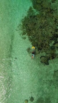 Aerial view of clear sea water and coral reef in Thousand Islands