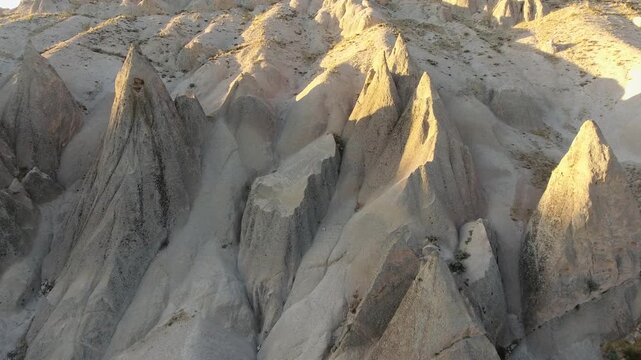 Aerial views sweep across Cappadocia fairy chimneys, valleys, and eroded tuff landscapes.