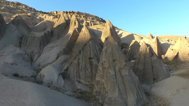 Aerial views sweep across Cappadocia fairy chimneys, valleys, and eroded tuff landscapes.