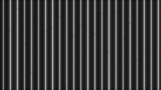 Abstract monochrome background featuring numerous vertical metallic light streaks and fine parallel lines