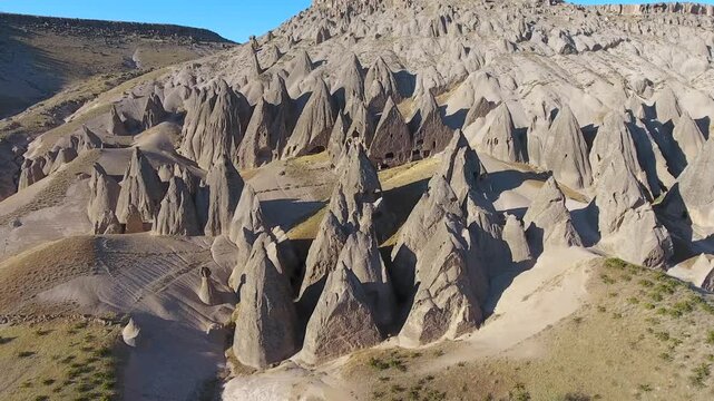 Aerial views sweep across Cappadocia fairy chimneys, valleys, and eroded tuff landscapes.