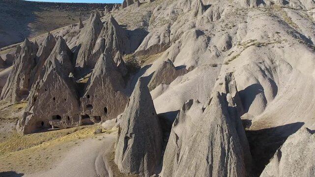 Aerial views sweep across Cappadocia fairy chimneys, valleys, and eroded tuff landscapes.