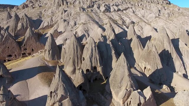 Aerial views sweep across Cappadocia fairy chimneys, valleys, and eroded tuff landscapes.