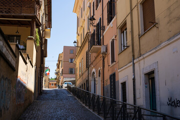 Fototapeta premium Frascati cobblestone lane with balconies and Italian flag
