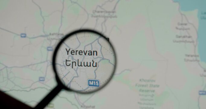 Detailed digital map of Yerevan, the capital of Armenia, being inspected with a magnifying glass to show the city's location and roadways, emphasizing research, travel, and geography
