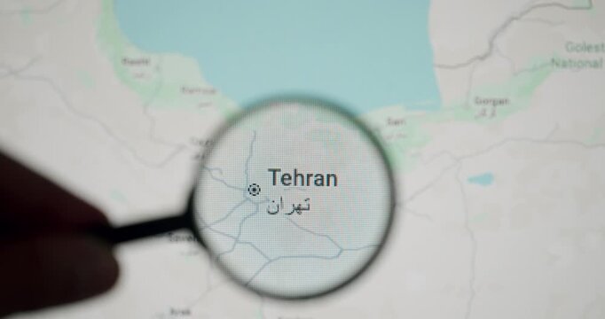 Close-up of a magnifying glass focusing on the city of Tehran on a digital map. Revealing details of the Iranian capital and its surroundings. Illustrating the concept of research and travel planning