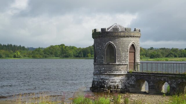 The Temple, a crenellated stone gazebo built as a fishing house, stands on a causeway projecting into Lough Key at Rockingham Demesne in County Roscommon, Ireland.