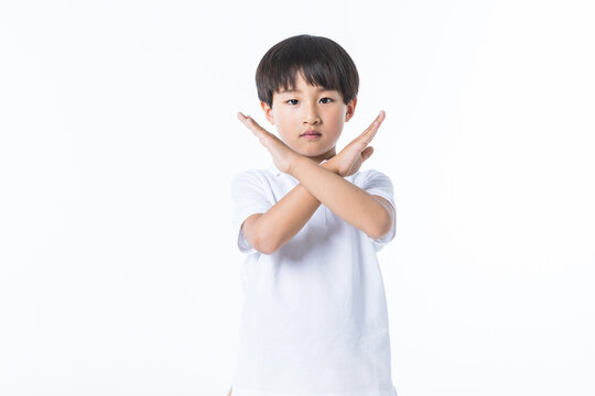 Boy Making Stop Gesture With Crossed Arms