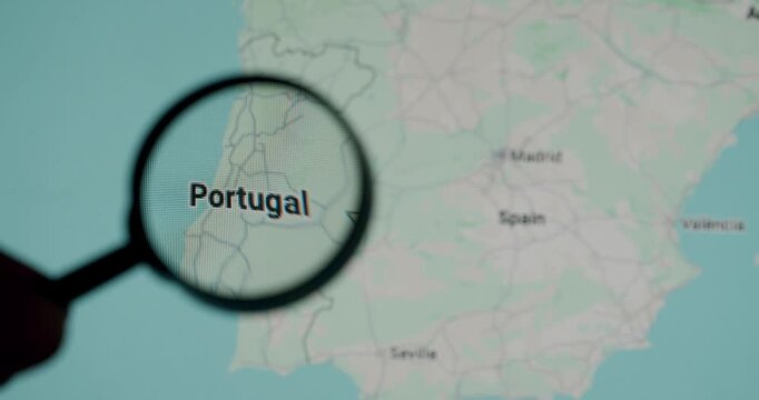 Person with a magnifying glass examining a map of Portugal and its capital, Lisbon, highlighting concepts of travel, geography, and exploration of the Iberian Peninsula and Europe