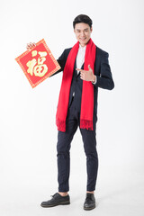Happy Asian man in suit holding Chinese Fu character decoration for Lunar New Year © ChauBich