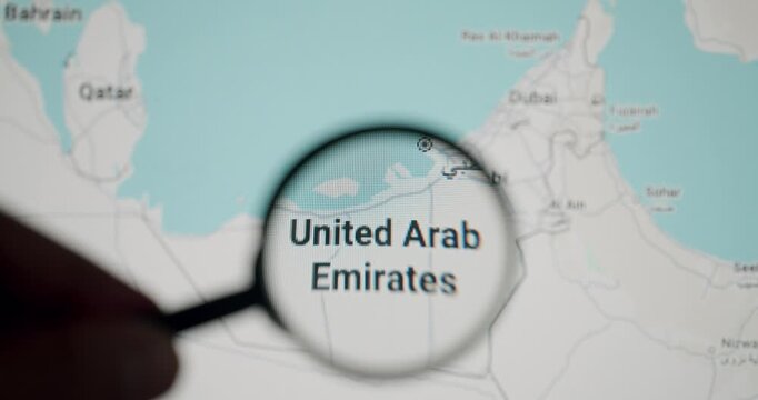 Hand holding magnifying glass moving over a digital map, focusing on the United Arab Emirates territory for travel planning, research, or geographical study of the Middle East region