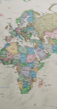 Detailed political world map slowly panning from the Atlantic Ocean, across Europe and Africa, to Asia and Australia, showing countries, capitals, oceans and geographic details. vertical