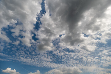 Vast sky filled with soft clouds drifting lazily during a bright day in mid-afternoon © beholdereye