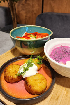 Draniki potato pancakes with sour cream, cold beet soup and salad