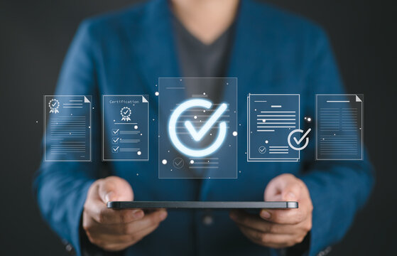 Quality assurance and certification concept with hands protecting digital approval checkmark and compliance documents. Symbol of quality control, verification, standards and business trust.