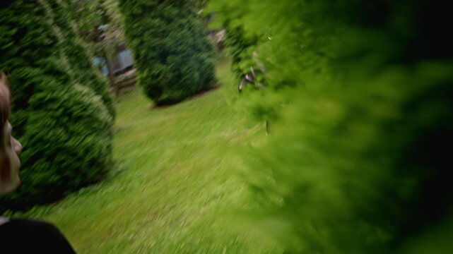 Diverse teenagers in Halloween makeup running through green hedge maze outdoors holding treat buckets. Footage suits autumn holiday advertising and seasonal youth campaign promotions