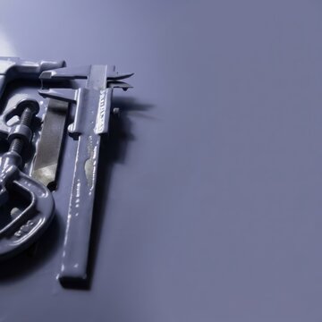 Vernier caliper on purple background with copy space and metal tools