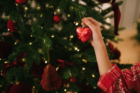 Cute 7-years old girl decorating Christmas tree