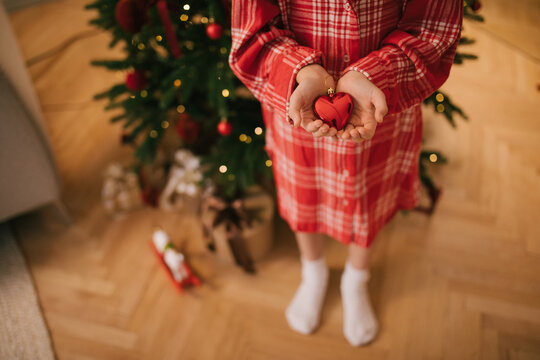Cute 7-years old girl decorating Christmas tree