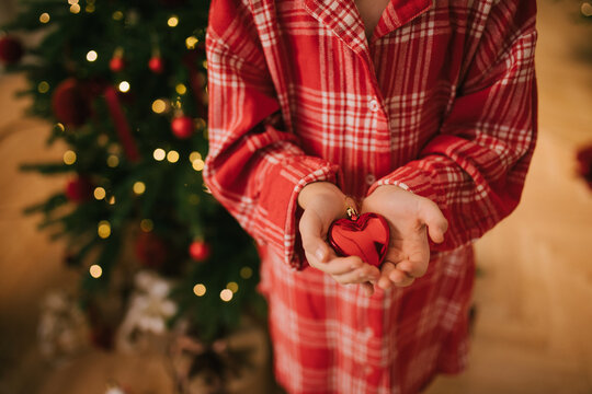Cute 7-years old girl decorating Christmas tree