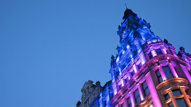 Illuminated Historic Architecture Shining Bright During The Annual Lumiere Festival In A Vibrant Urban Display Against A Clear Evening Sky
