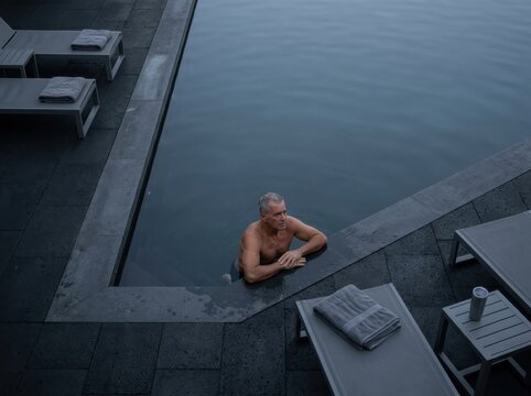 Infinity Pool Retreat With Relaxed Man in Luxury Spa Setting