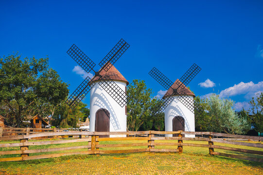 traditional white windmills under bright blue sky in countryside