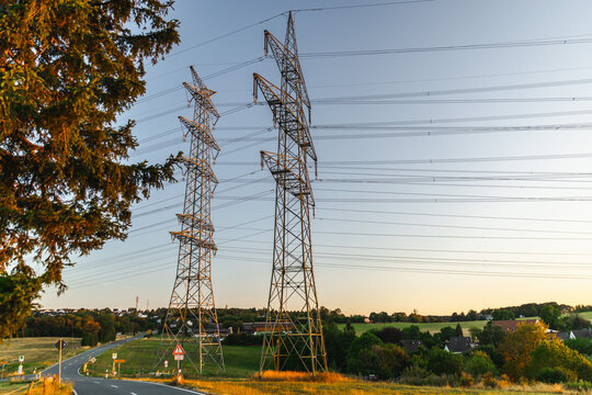High-Voltage Transmission Towers Above German Countryside
