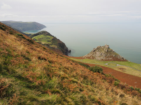 Sweeping coastal vista looking down from South Cleave towards Castle Rock and the Bristol Channel across the Valley of Rocks near Lynton, Exmoor, North Devon, UK