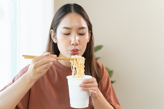 Close-up shot of person enjoy eating instant noodle.