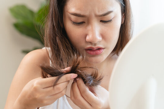 Young woman scratching her head feeling itch from dermatology problem