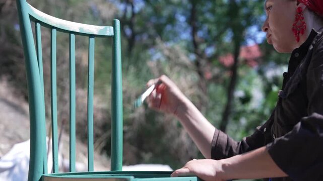 Woman Painting Old Chair for Furniture Restoration
