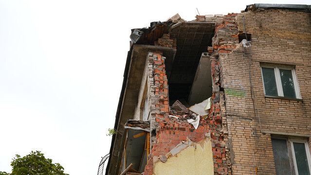 Damaged building structure with exposed brick walls during demolition and urban redevelopment process