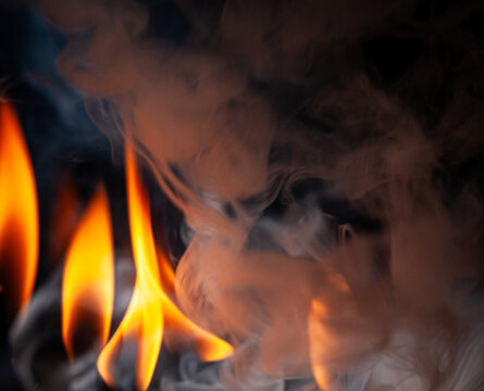 Fire and smoke create a dynamic scene indoors during an evening gathering