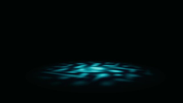 Cyan and teal circular light projection illuminates a dark stage surface for technical product reveal in a 3D animation