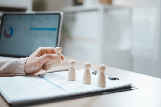 Wooden figure marks human resources development develop resume employment choices, then marks human resources development develop resume employment choices in a dim warm soft calm bright sunlit room.