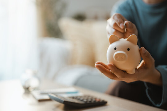 Ceramic saver shows piggy bank saving spare money playful piggy secure bank marks, then shows piggy bank saving spare money playful piggy secure bank marks in a dim warm soft calm bright sunlit room.