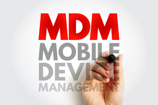 MDM Mobile Device Management handwritten on transparent screen by hand. Business technology concept for enterprise mobile control, security, and administration of connected smart devices