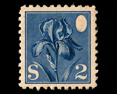 Vintage blue postage stamp featuring detailed iris flower illustration with moon and S 2 denomination