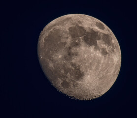 Waxing Gibbous Moon with Detailed Lunar Surface Against Dark Night Sky © roobcio