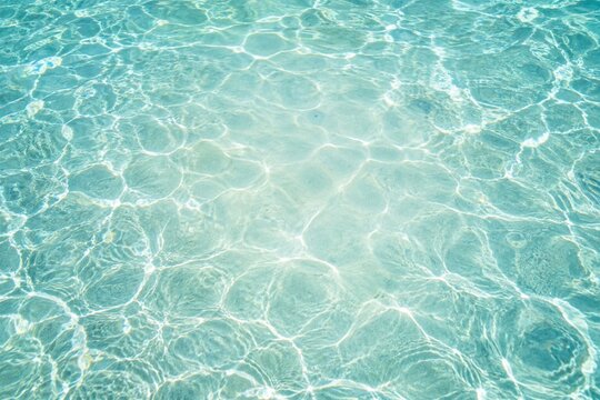 Sunlit turquoise water with gentle ripples and light patterns