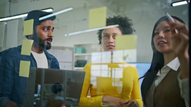 Collaboration and analysis by business people working in office.Planning,innovation,vision,business marketing strategy.Group,team discussing with sticky notes a schedule for future project together