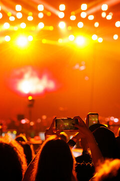 Concert crowd holding up smartphones at festival