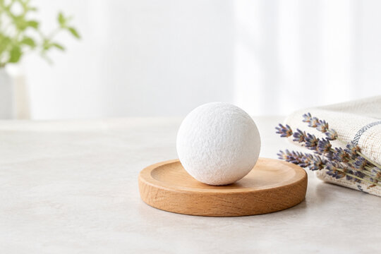 Camphor ball on wooden coaster with cotton cloth and dried lavender
